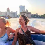 Traveler enjoying a premium speedboat ride near the Gateway of India and Taj Mahal Palace Hotel before departing for Elephanta Caves in Mumbai.
