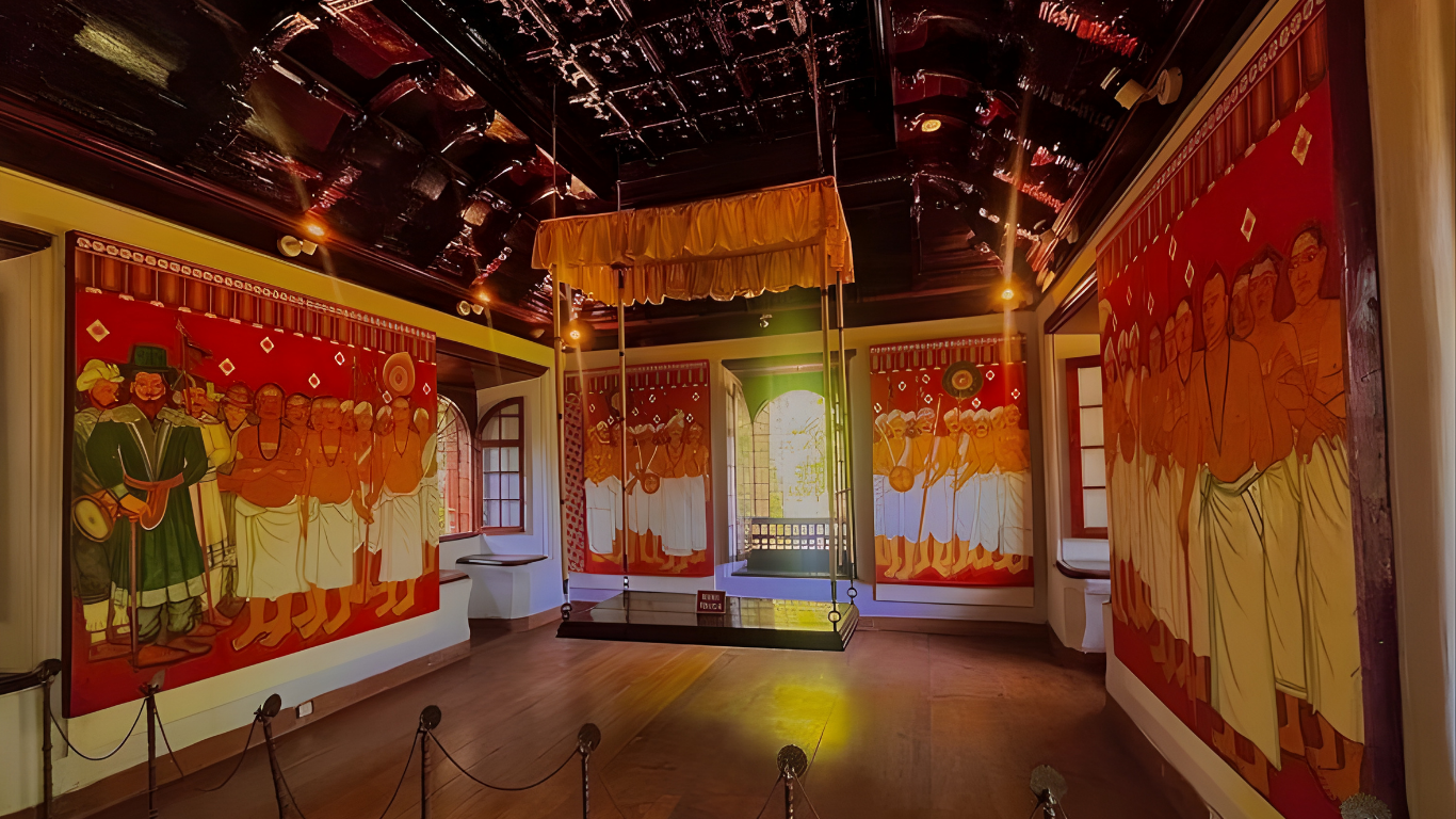 Historic Kerala palace hall decorated with traditional mural paintings