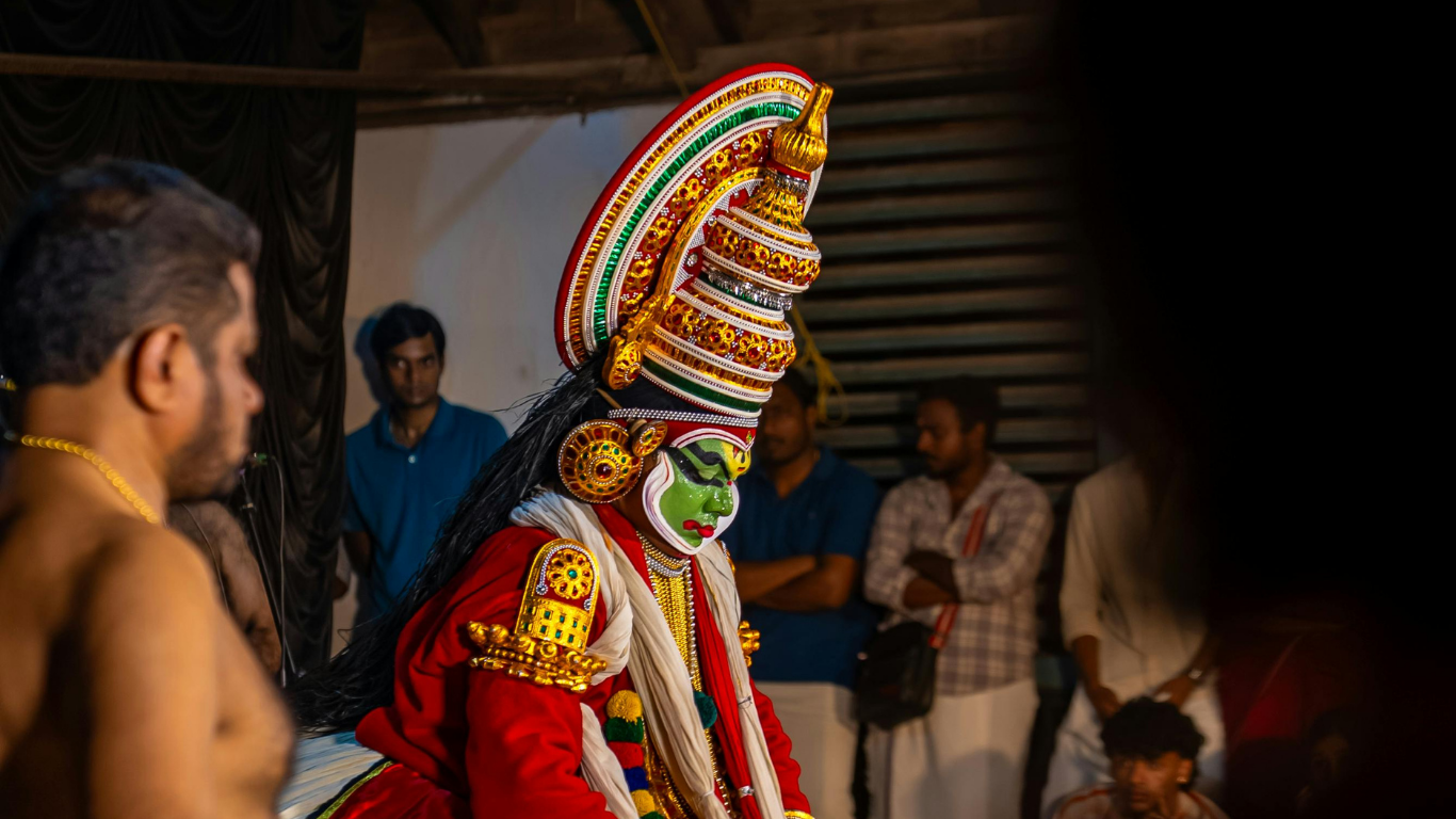 Kathakali dancer in traditional costume preparing for a performance in Kerala