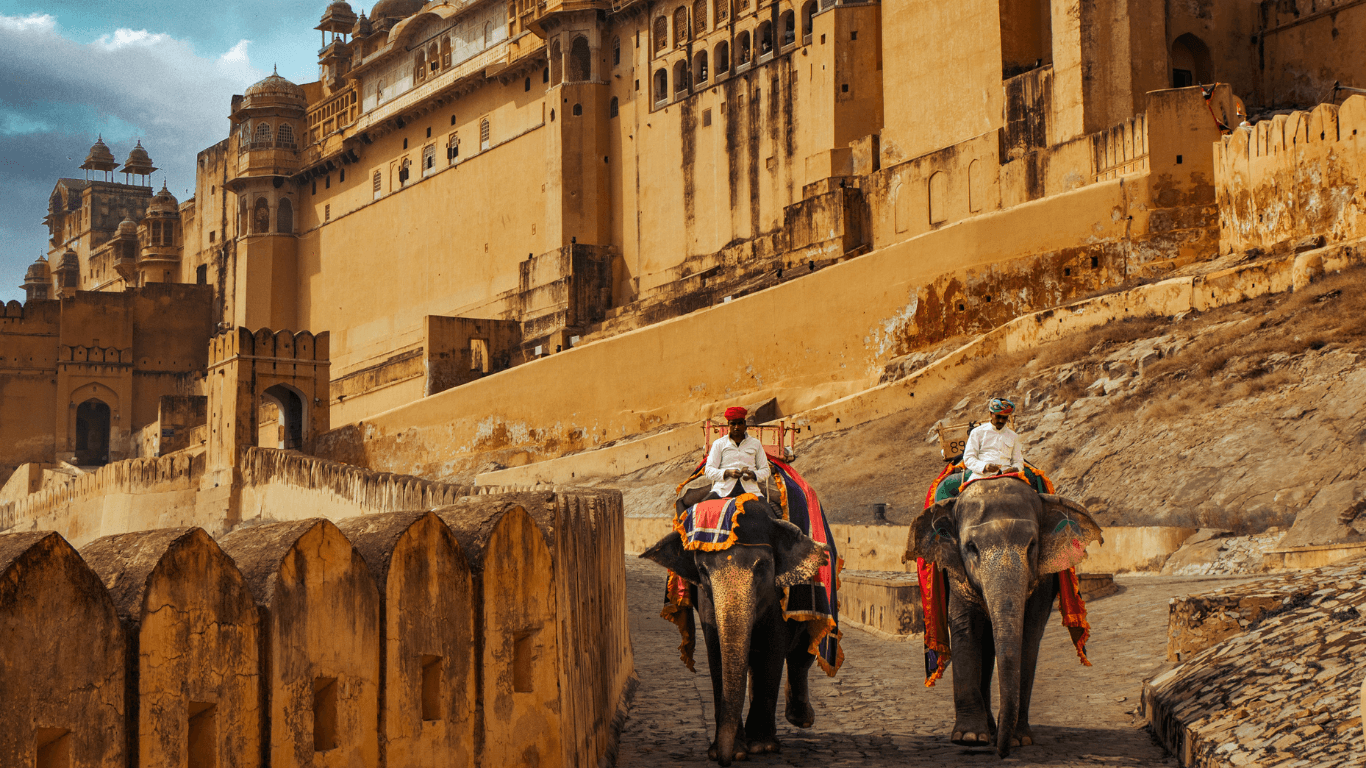 Elephant ride at Amber Fort in Jaipur with traditional mahouts and historic fort walls in the background.