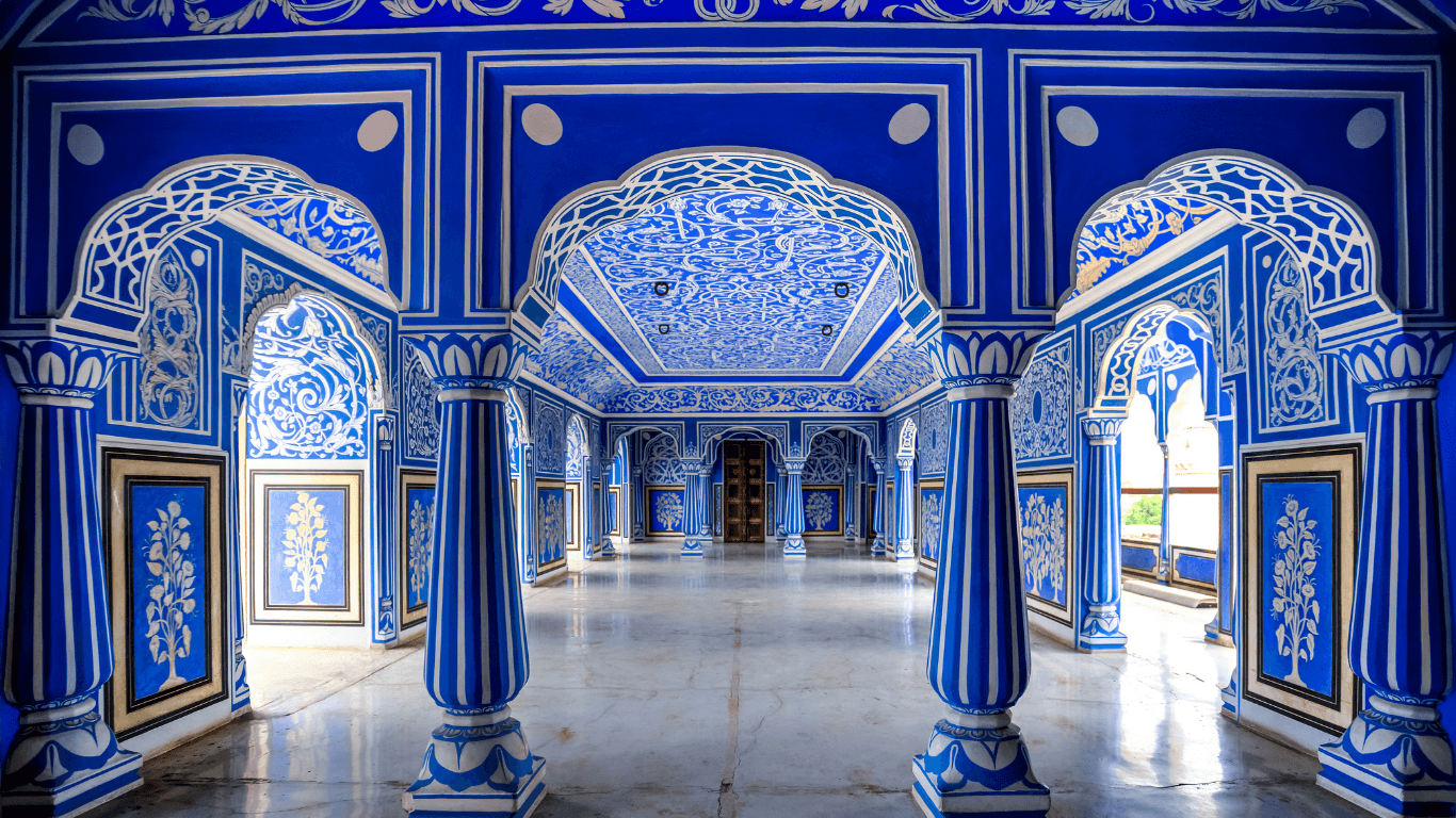 Blue fresco palace interior in Jaipur experienced during a Golden Triangle shore excursion in India