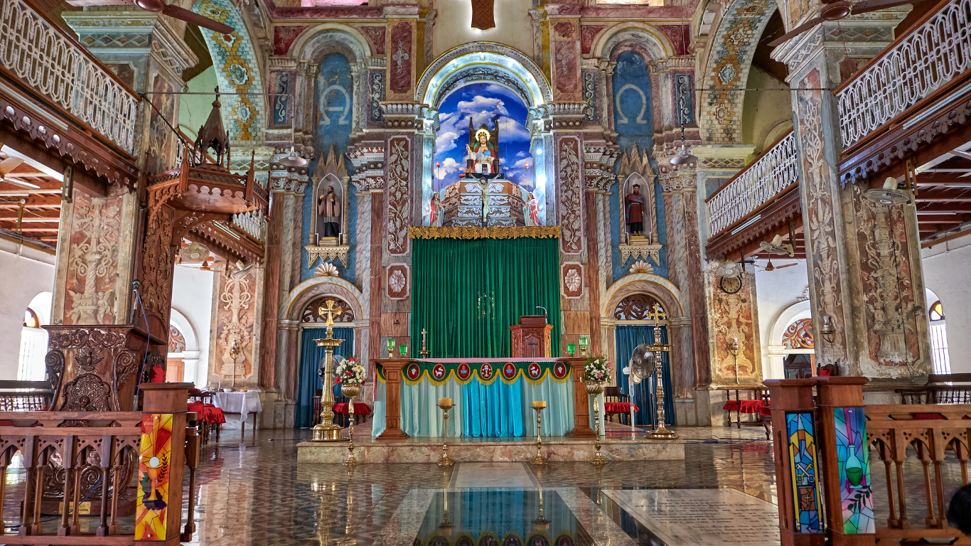 Ornate church interior in Old Goa with altar and arches