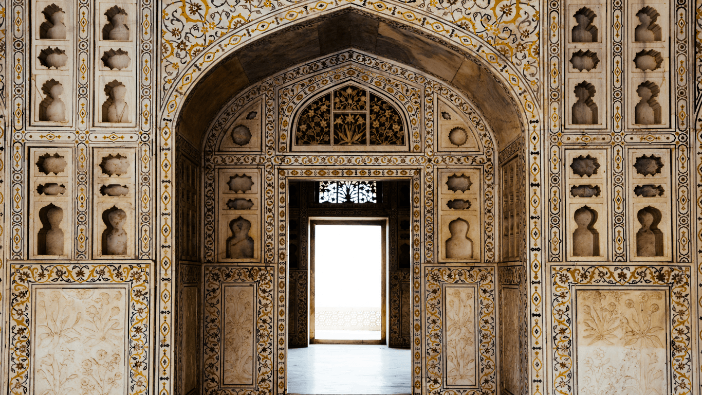 Intricate marble inlay arch inside a Mughal monument in Agra visited during a Golden Triangle