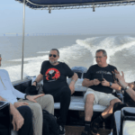 How to Reach Elephanta Caves by Speedboat (Complete Guide) Travelers relaxing and chatting during a scenic boat cruise along the Mumbai coastline.