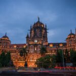 Chhatrapati Shivaji Maharaj Terminus illuminated at night with traffic trails and historic architecture