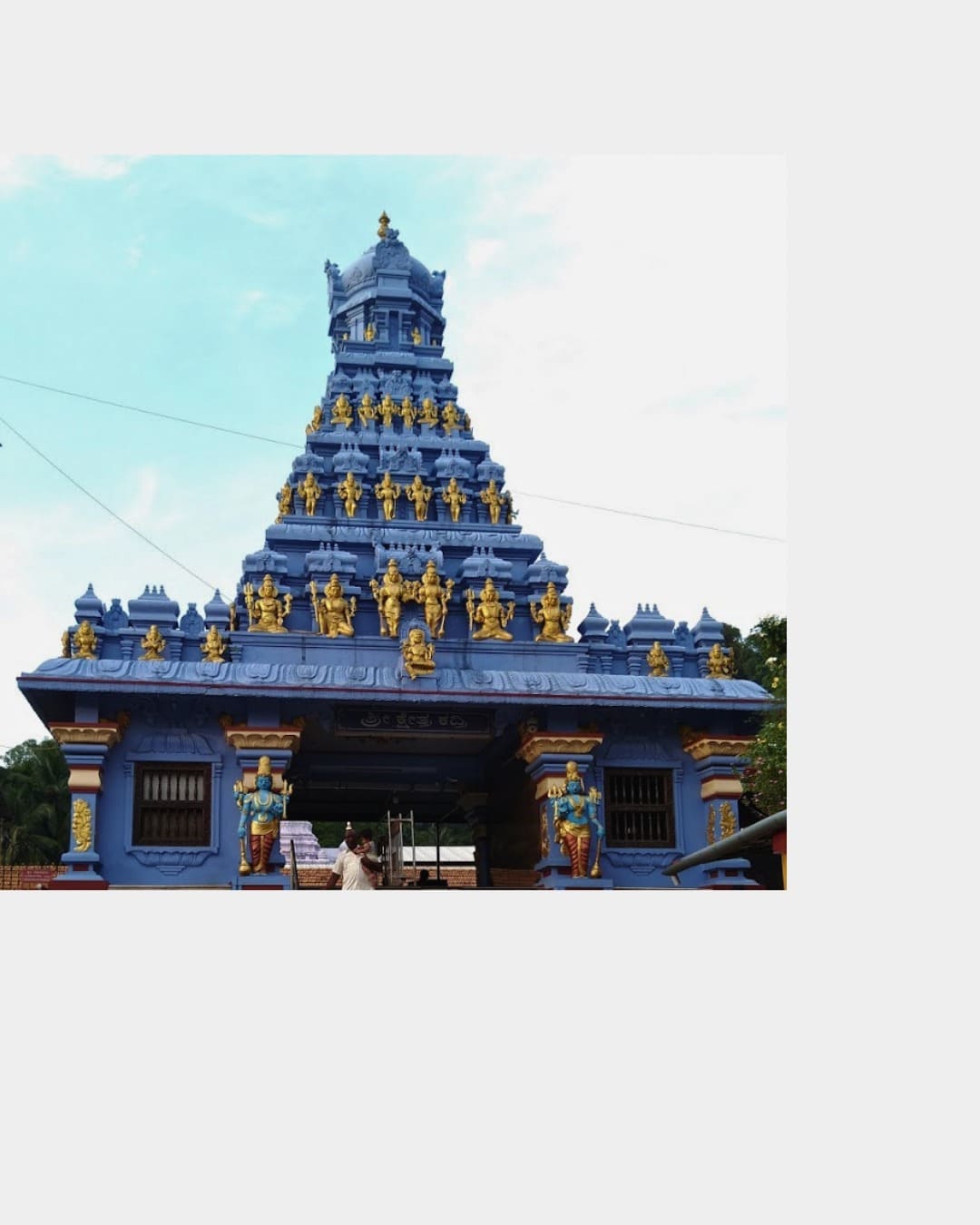 Traditional Hindu temple in Mangalore featuring ornate blue and gold gopuram architecture