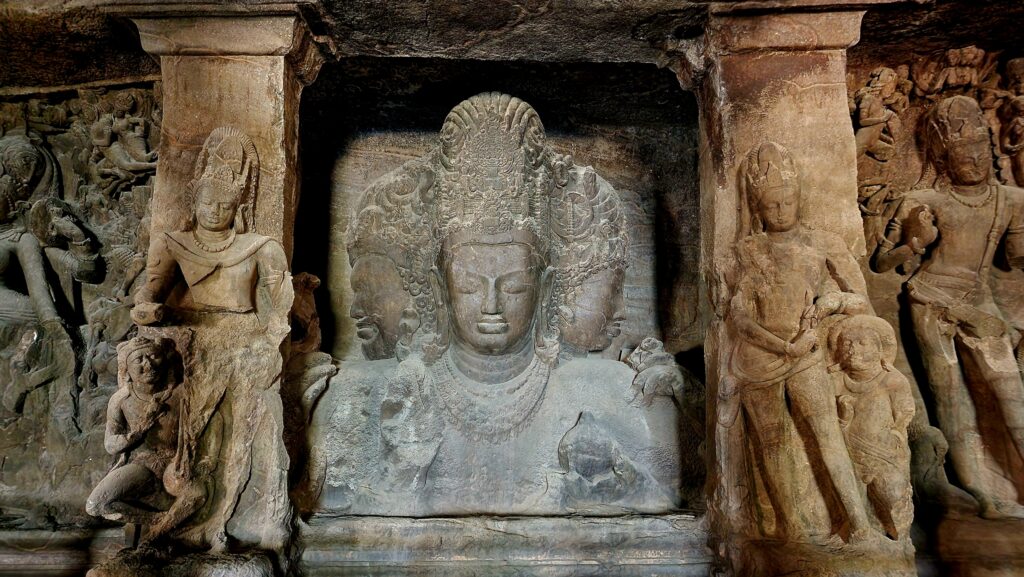 Iconic three faced Shiva sculpture carved inside Elephanta Caves UNESCO heritage site
